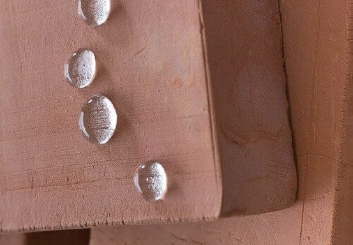 Block of wood with droplets showing water repellent feature of Properla